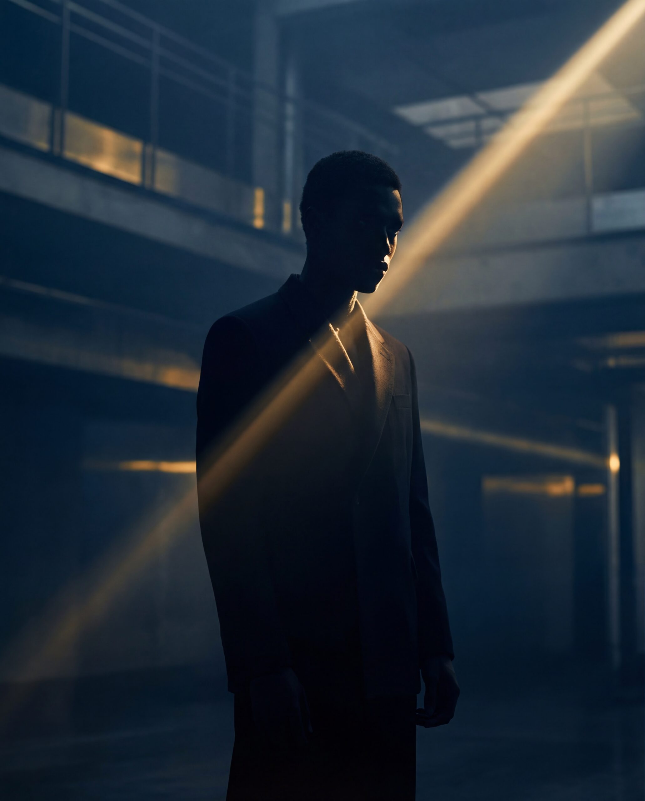 Person in suit with gold light beam across face